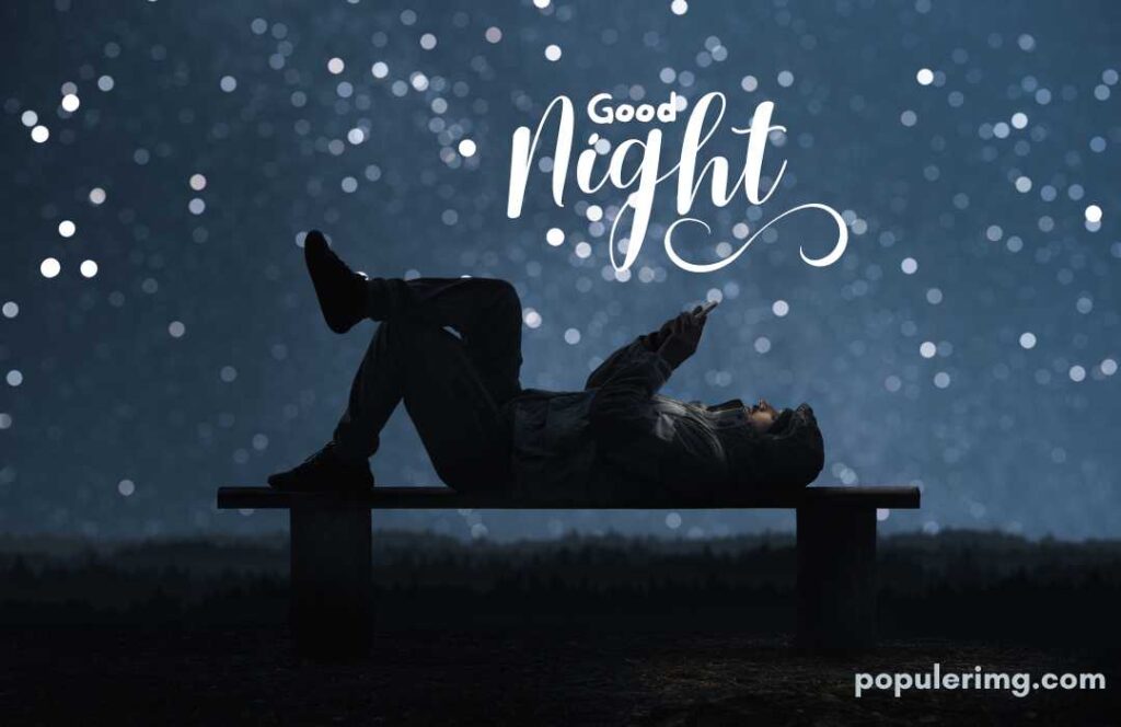 The Good Night Image Shows A Night Scene Of A Man Who Appears To Be Playing On A Mobile Phone While Lying On Top Of A Table