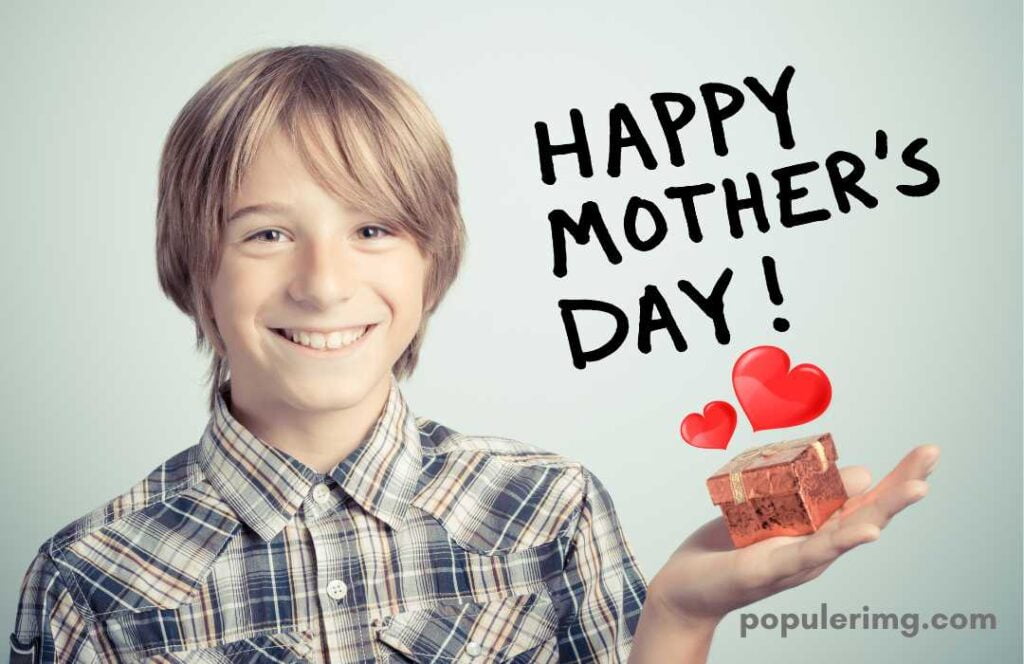 In This Image, A Smiling Boy Is Standing With A Small Gift In His Hand. (Happy Mother Day)