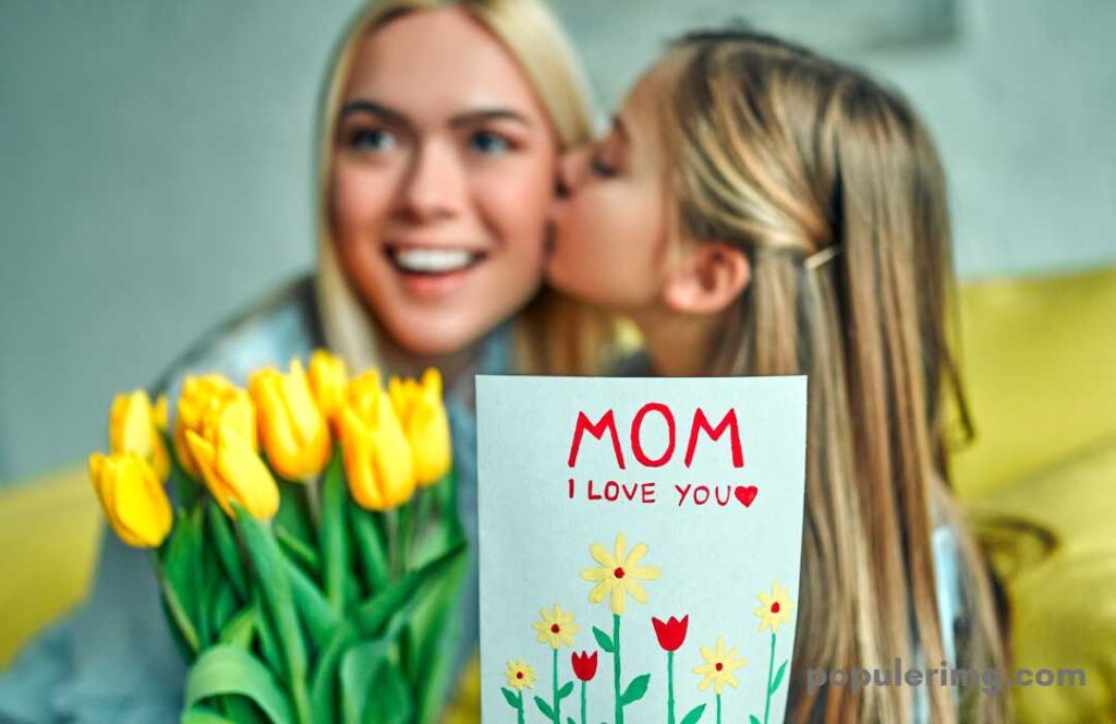 Cute Girl Kissing While Giving Flowers To Her Mother (Happy Mother'S Day)
