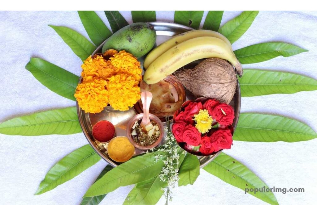 Yellow Flowers In A Small Plate, Mangoes, Bananas, Coconut, Rose Flowers, Vermilion, Turmeric, Green Leaves Garnished