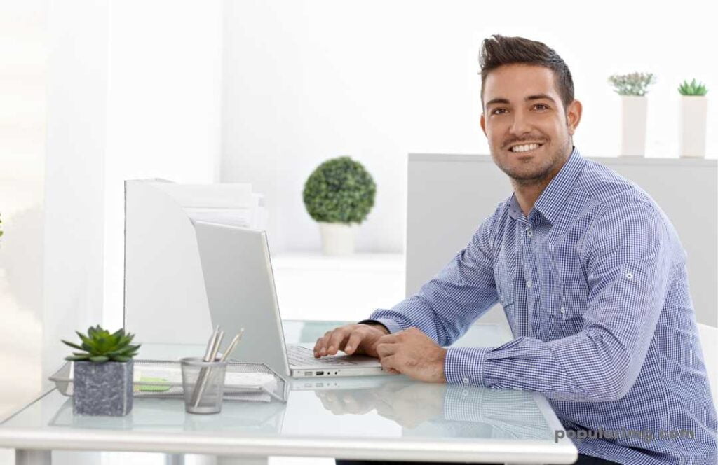 Happy Image Of Smiling Boy Working On A Laptop 