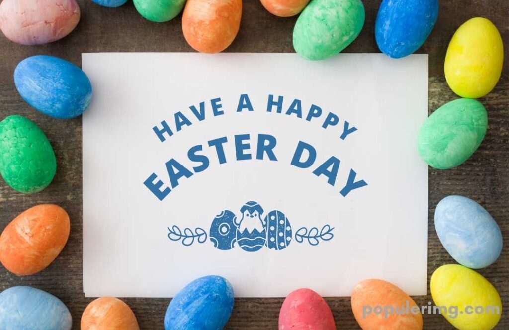 In The Image There Is A Cute Envelope With Colored Stones Around It With Happy Easter Day Written On It.