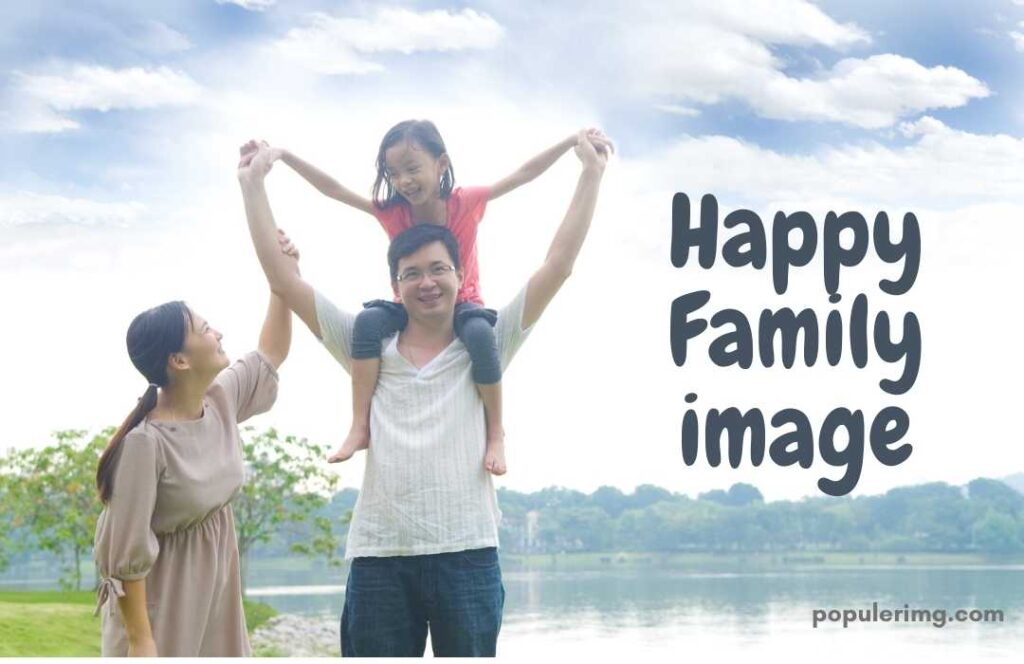 Father Laughing With His Daughter On His Shoulder And Mother Holding Daughter'S Hand