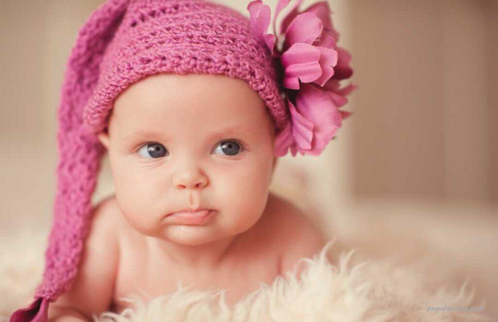 A Baby Wearing A Pink Knitted Hat.	